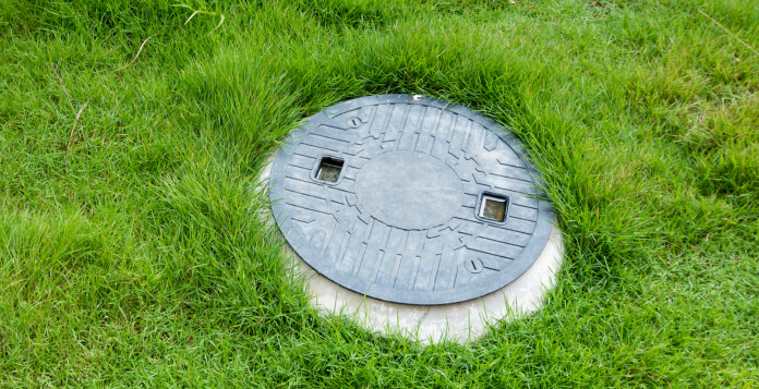 Manhole cover in grass